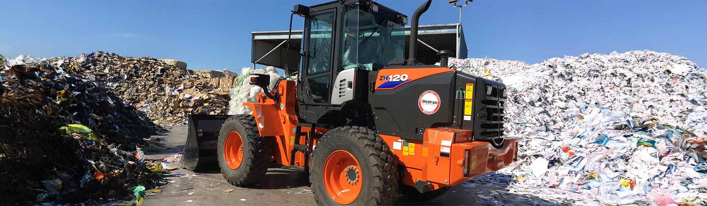 heavy machine rentals from westrax machinery image of hitachi front loader with recycling piles