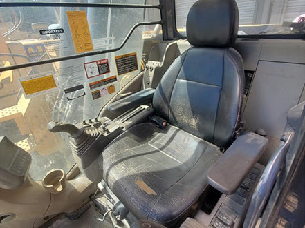 Interior of a deere 225d cabin excavator with a focus on the driver's seat and dashboard heavy machinery for sale near corona ca by westrax machinery