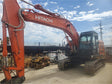 Red Hitachi excavator on a construction site with a blue sky heavy machinery for sale near corona ca by westrax machinery